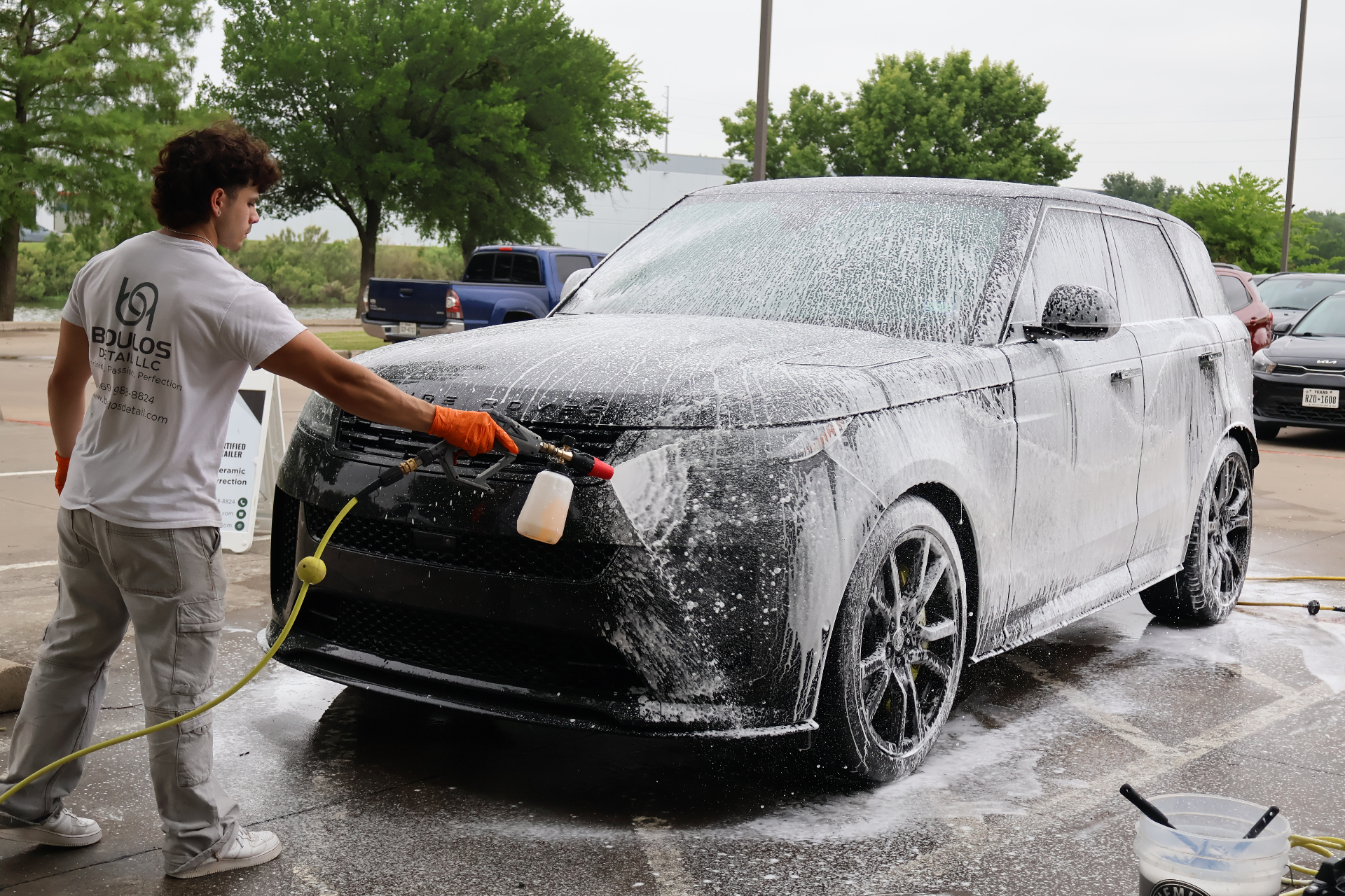 Boulos Detail technician foam washing a Range Rover