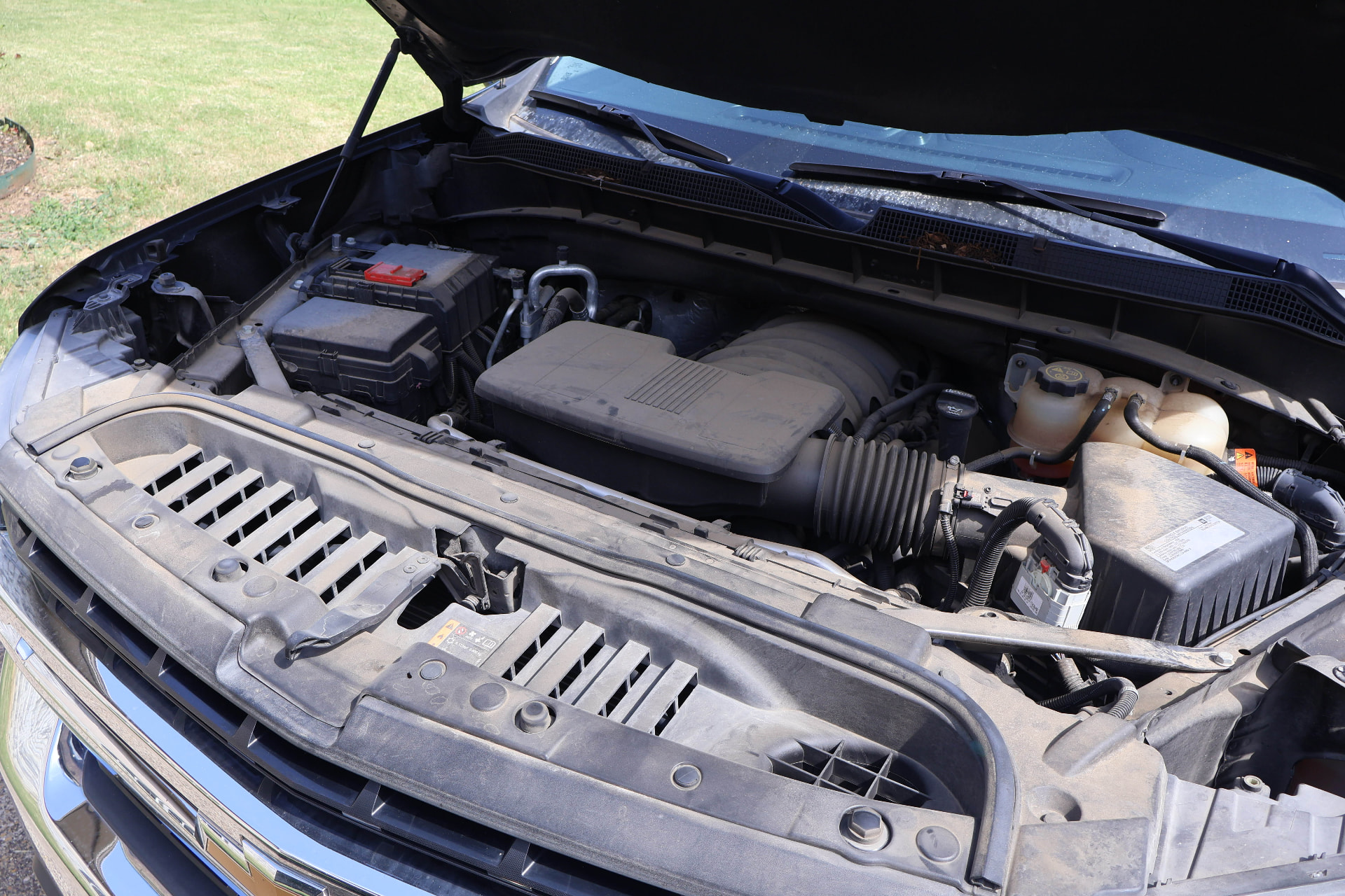 Dusty engine bay before Boulos Detail engine bay detailing