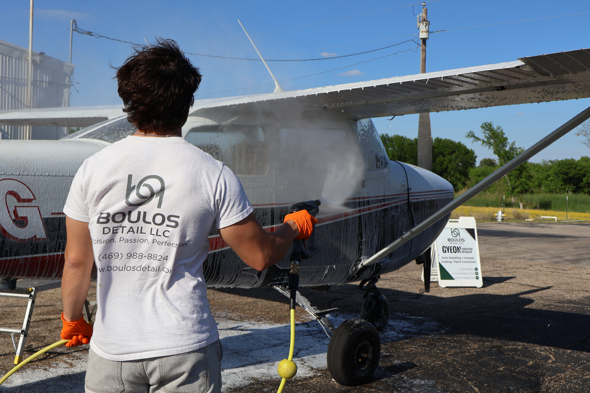 Boulos Detail technician washing a Cessna aircraft